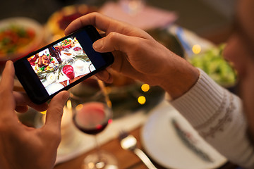 Image showing hands photographing food at christmas dinner