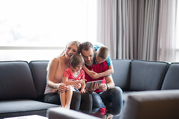 Image showing happy young couple spending time with kids