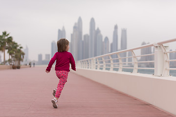 Image showing cute little girl on the promenade by the sea