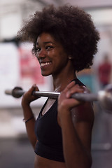 Image showing black woman lifting empty bar