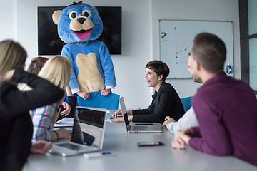 Image showing boss dresed as bear having fun with business people in trendy of