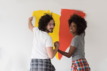 Image showing multiethnic couple painting interior wall