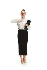 Image showing Full length portrait of a female teacher holding a folder isolated against white background