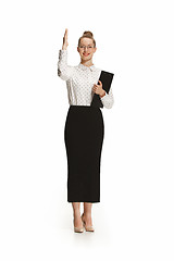 Image showing Full length portrait of a female teacher holding a folder isolated against white background