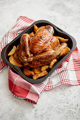 Image showing Roasted chicken or turkey with potatoes in black steel mold