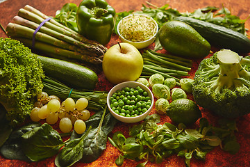 Image showing Fresh green vegetables and fruits assortment placed on a rusty metal