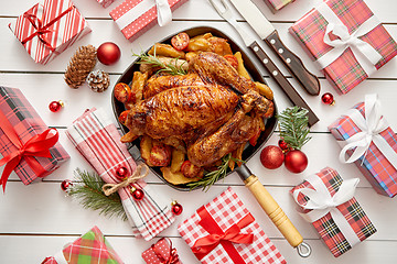 Image showing Roasted whole chicken or turkey served in iron pan with Christmas decoration