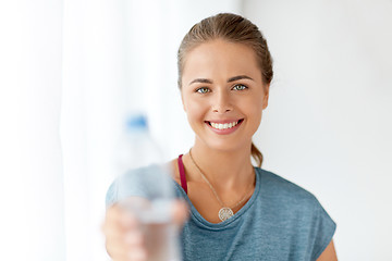 Image showing happy woman showing bottle of water