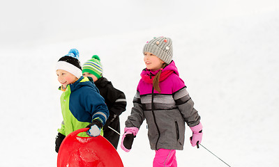 Image showing happy little kids with sleds in winter