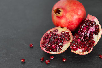 Image showing close up of pomegranate on stone table