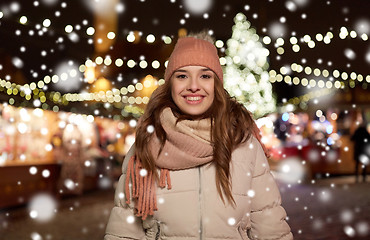 Image showing happy young woman at christmas market in winter