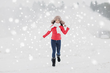 Image showing happy woman in winter fur hat outdoors