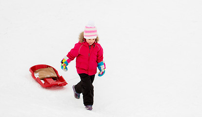 Image showing little girl with sled on snow hill in winter