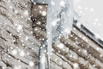 Image showing icicles hanging from building drainpipe