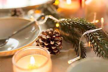 Image showing pine cone and candles burning on christmas table