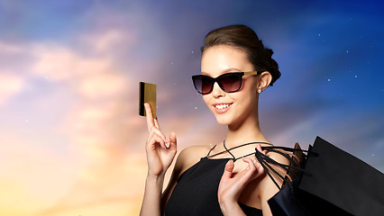 Image showing happy woman with credit card and shopping bags