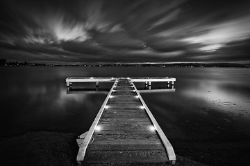 Image showing Timber jetty with moody skies at night
