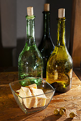 Image showing three bottles of olive oil and parmesan