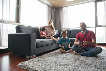 Image showing Happy family playing a video game