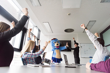 Image showing boss dresed as bear having fun with business people in trendy of