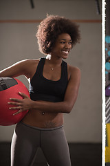 Image showing black woman carrying crossfit ball