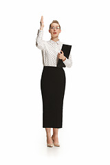 Image showing Full length portrait of a female teacher holding a folder isolated against white background