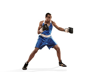 Image showing Sporty man during boxing exercise making hit. Photo of boxer on white background