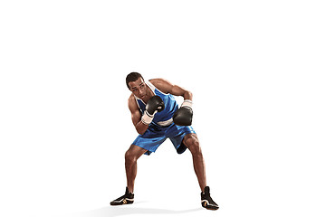 Image showing Sporty man during boxing exercise making hit. Photo of boxer on white background