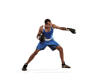Image showing Sporty man during boxing exercise making hit. Photo of boxer on white background