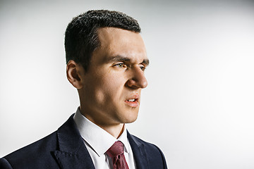 Image showing Three-quarter portrait of a businessman with disgust face. Confident professional with piercing look in the foreground of the camera.