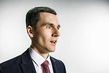 Image showing Three-quarter portrait of a businessman with surprised and smiling face. Confident professional with piercing look in the foreground of the camera.