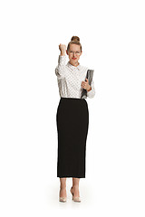 Image showing Full length portrait of a smiling female teacher holding a folder isolated against white background