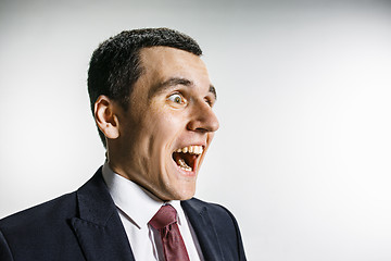 Image showing Three-quarter portrait of a businessman with surprised and smiling face. Confident professional with piercing look in the foreground of the camera.