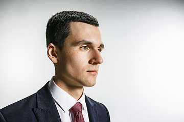 Image showing Three-quarter portrait of a businessman with very serious face. Confident professional with piercing look in the foreground of the camera.