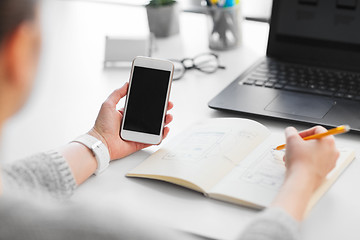 Image showing web designer working on smartphone user interface