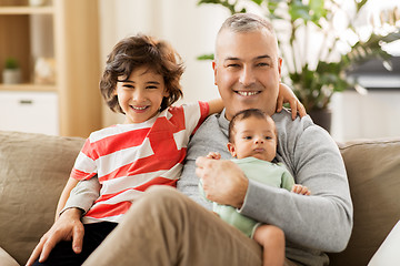 Image showing happy father with preteen and baby son at home