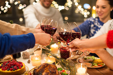 Image showing close up of friends with wine celebrate christmas