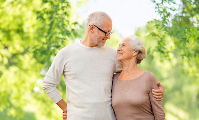 Image showing senior couple hugging over natural background