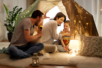 Image showing father telling scary stories to his daughter