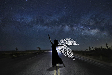 Image showing Girl Light Painted in the Desert Under the Night Sky