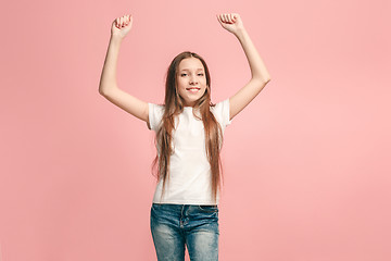 Image showing Happy success teen girl celebrating being a winner. Dynamic energetic image of female model