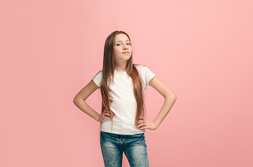 Image showing The happy teen girl standing and smiling against pink background.