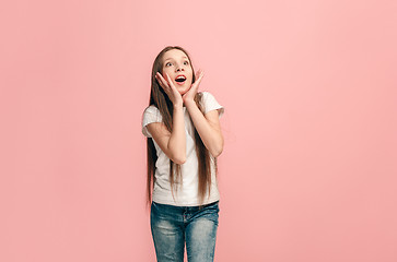 Image showing Beautiful teen girl looking suprised isolated on pink