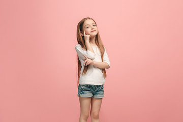 Image showing The happy teen girl standing and smiling against pink background.