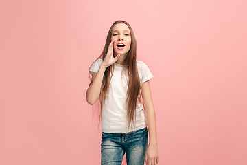 Image showing young casual teen girl shouting at studio