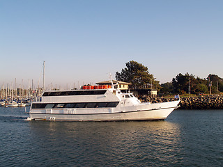 Image showing Large motor yacht heading out of marina