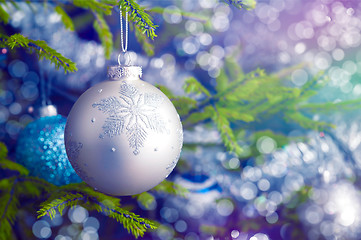 Image showing Christmas-tree decoration bauble on decorated Christmas tree bac