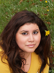 Image showing Young plump woman yellow sweater with flower