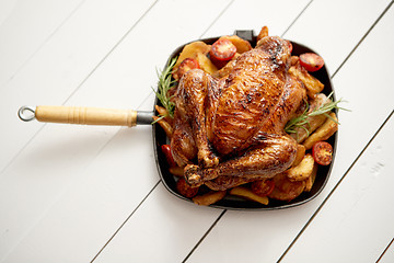 Image showing Roasted whole chicken in cast iron black pan