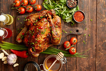 Image showing Roasted whole chicken or turkey served with chilli pepers and chive